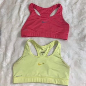 2 nike sports bras: pink is a small, yellow is a size medium.